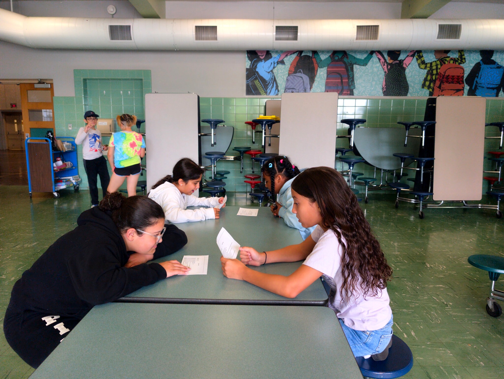 Students working in pairs on a theatre activity in a classroom