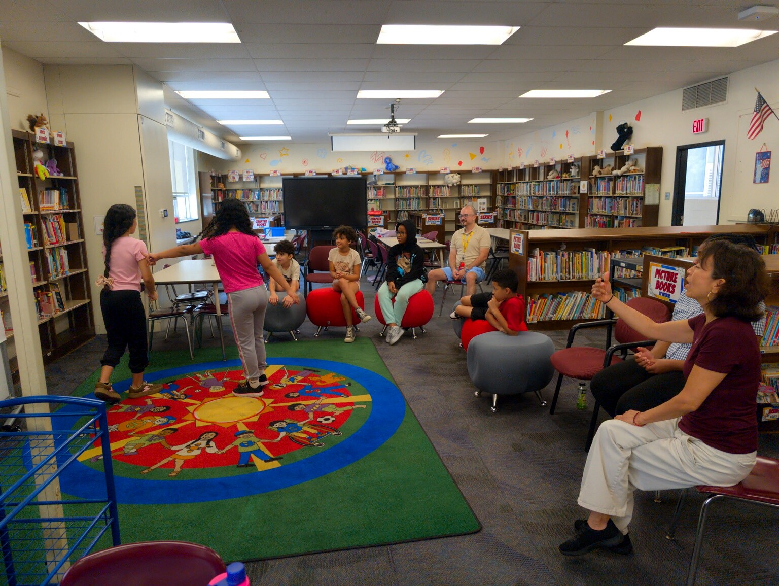 Students participating in a group theatre exercise in a classroom