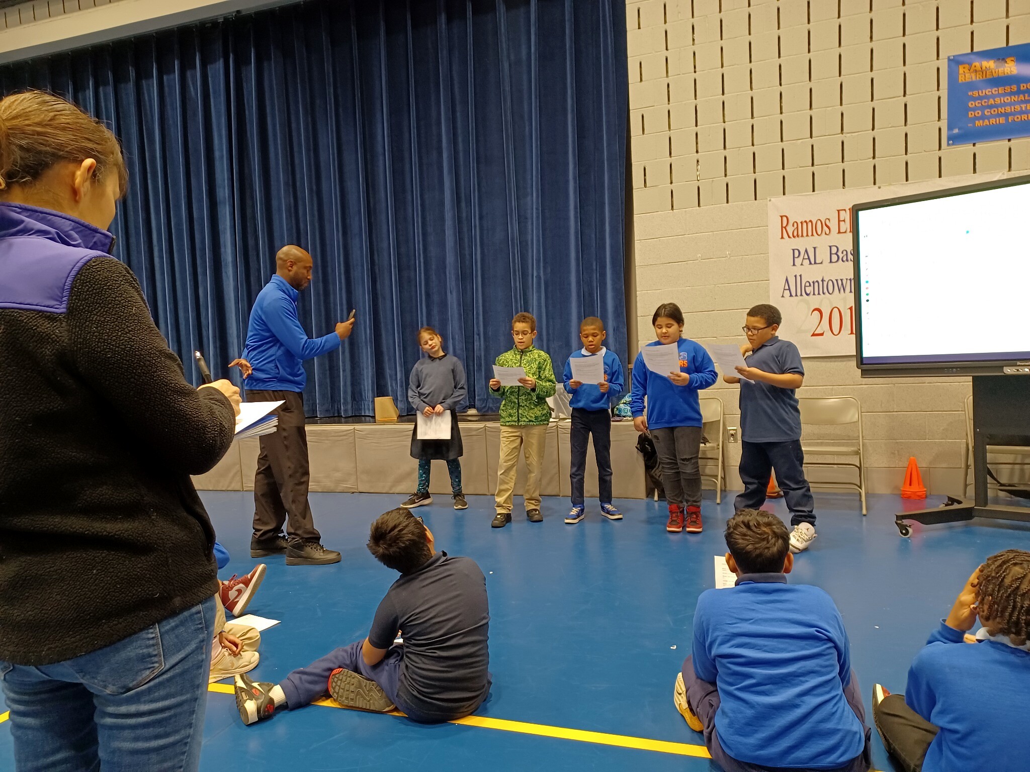 Ramos Elementary School students rehearsing together in front of an audience